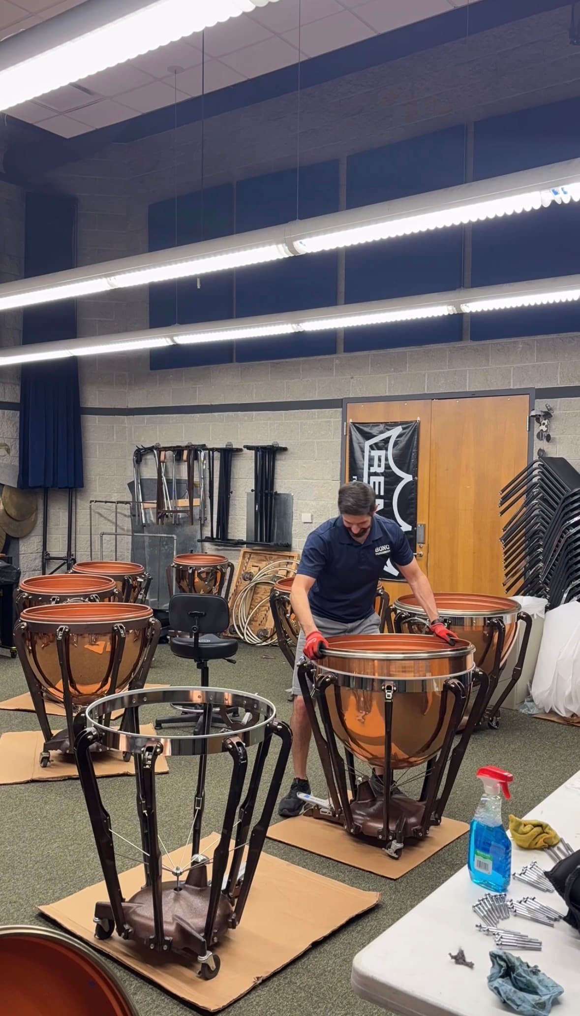 A Bono Percussion technician putting a timpani bowl back into its frame