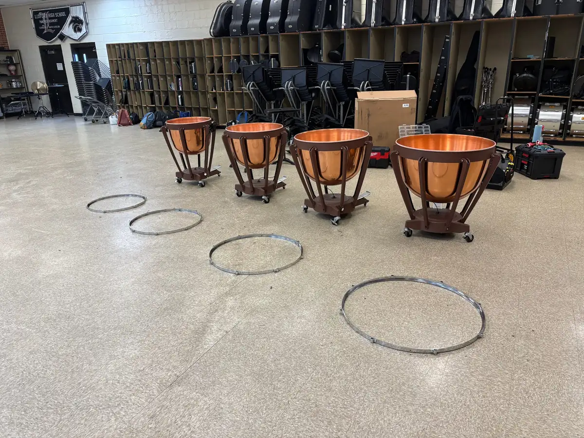 Four school timpani with tuning hoops removed, staged for a head change