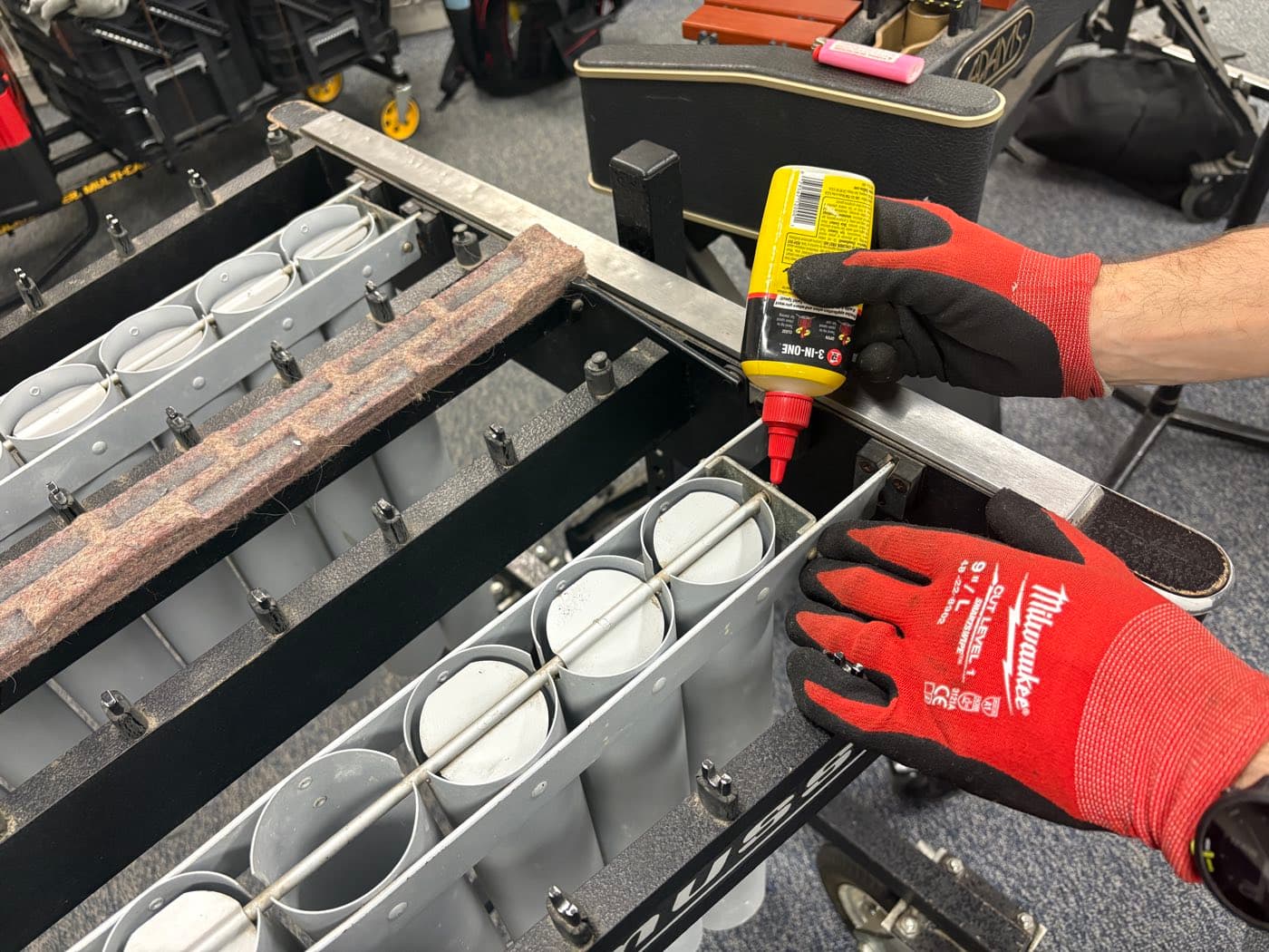 A technician lubricating the resonator fans on a keyboard percussion instrument