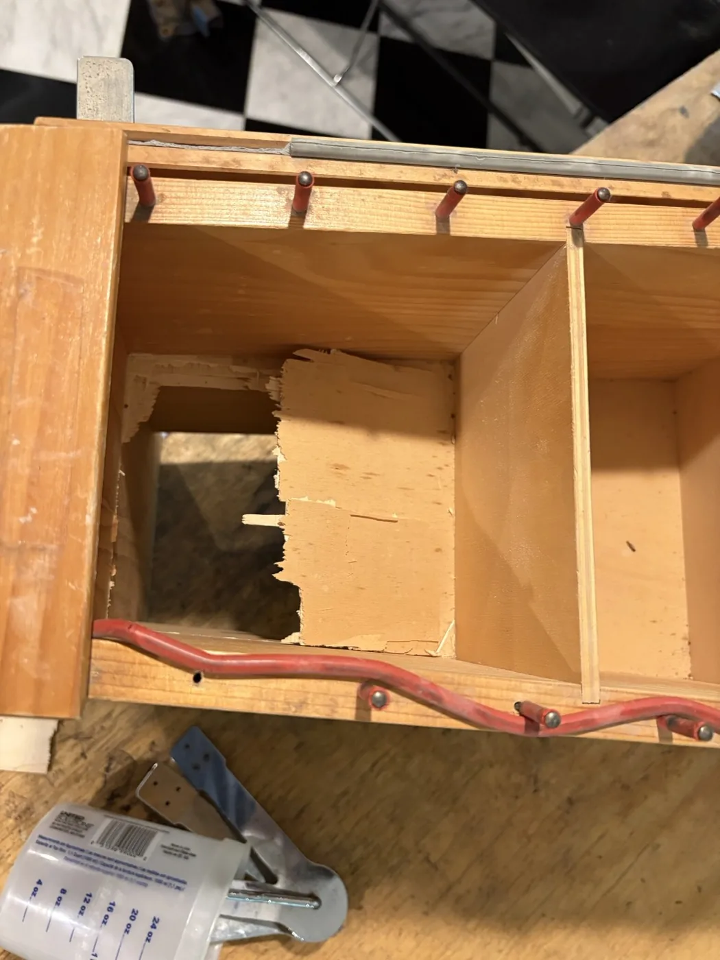 An Orff resonator box before repair, the inner panel splintered through