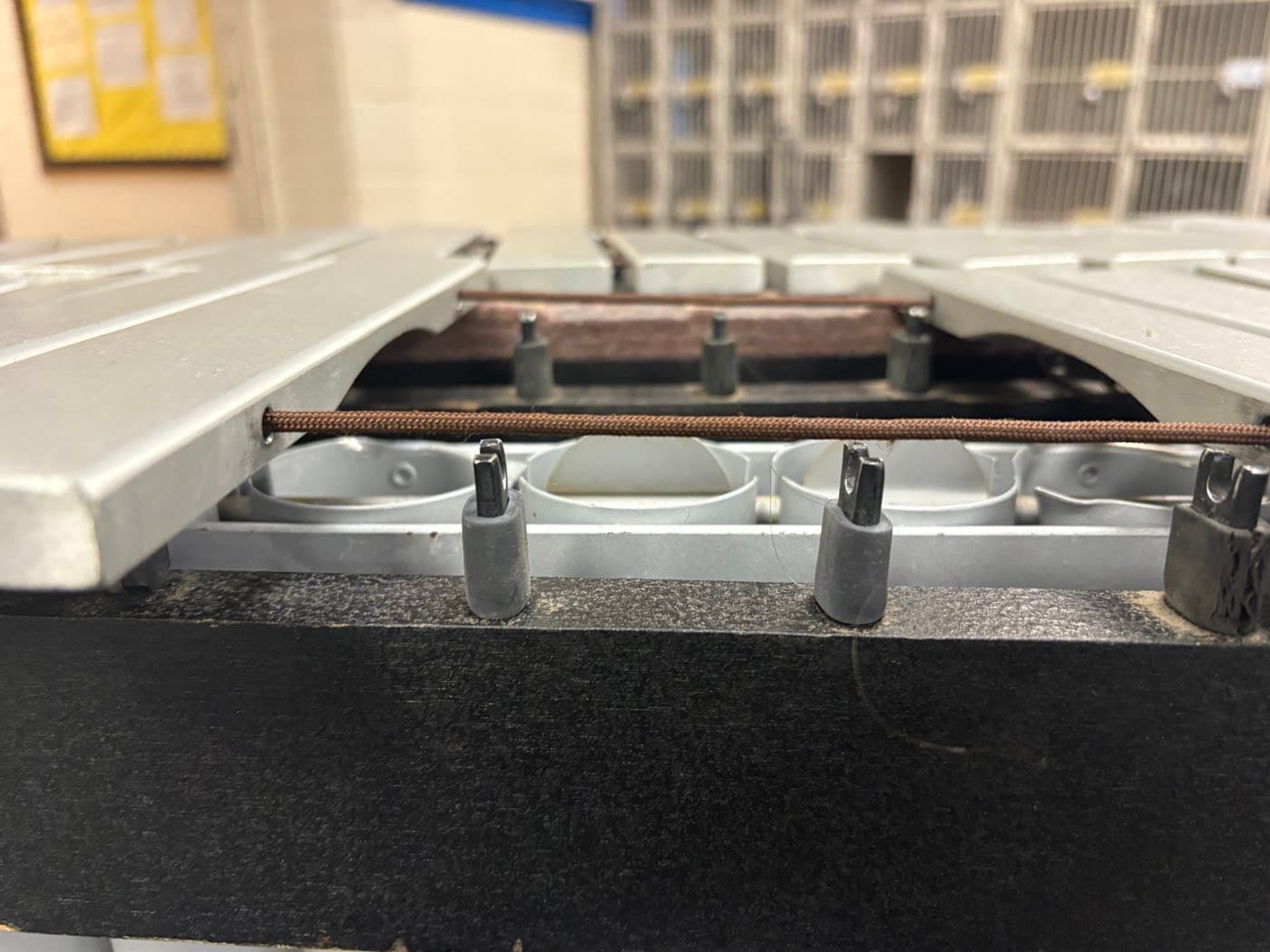A keyboard suspension post with a new cord and rubber insulator fitted