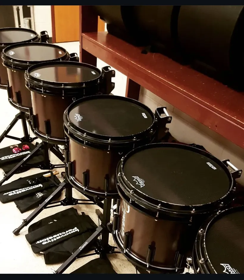A row of Dynasty marching snare drums lined up for tuning