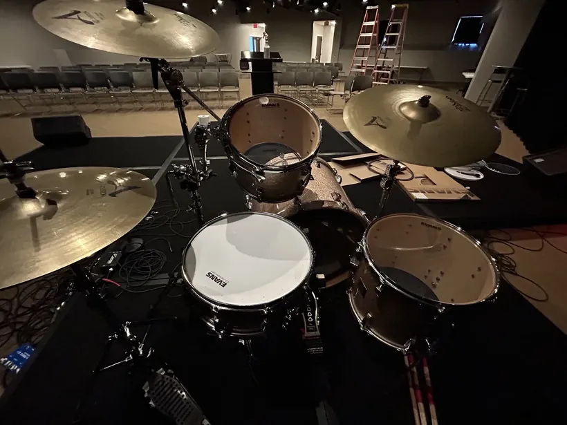 A drum set on stage, set up and ready to tune