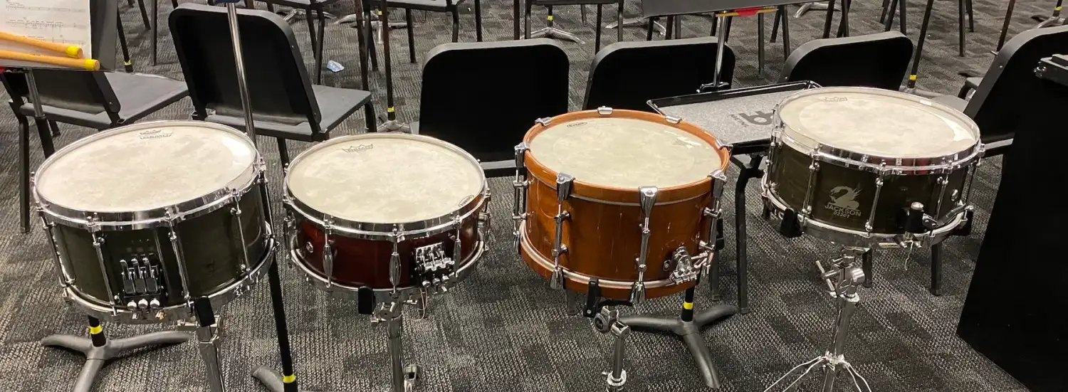Snare drums lined up on stands