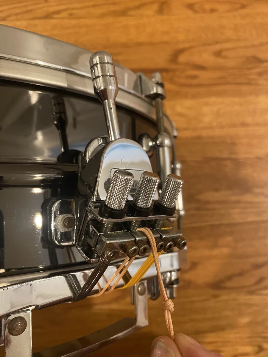 Pearl Philharmonic concert snare's strainer, with individual tension screws for each snare wire