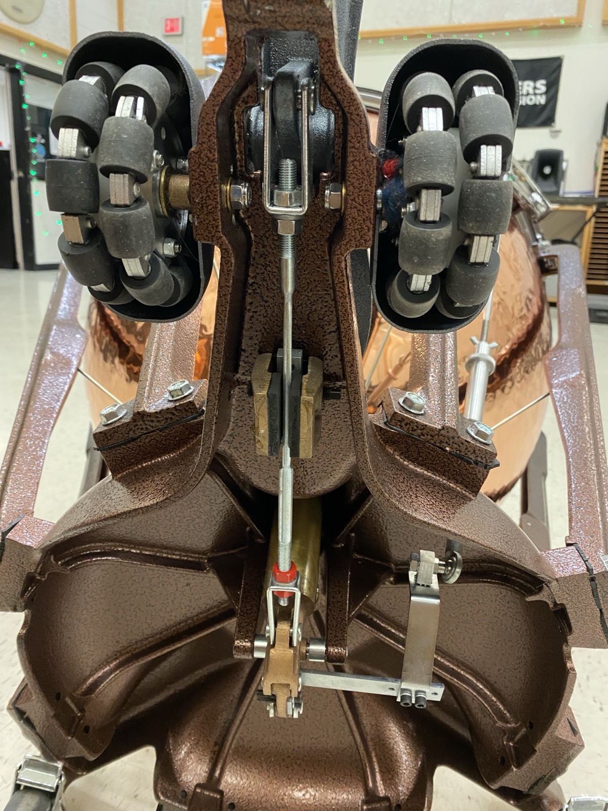 Underside of a timpani showing the wheels and legs