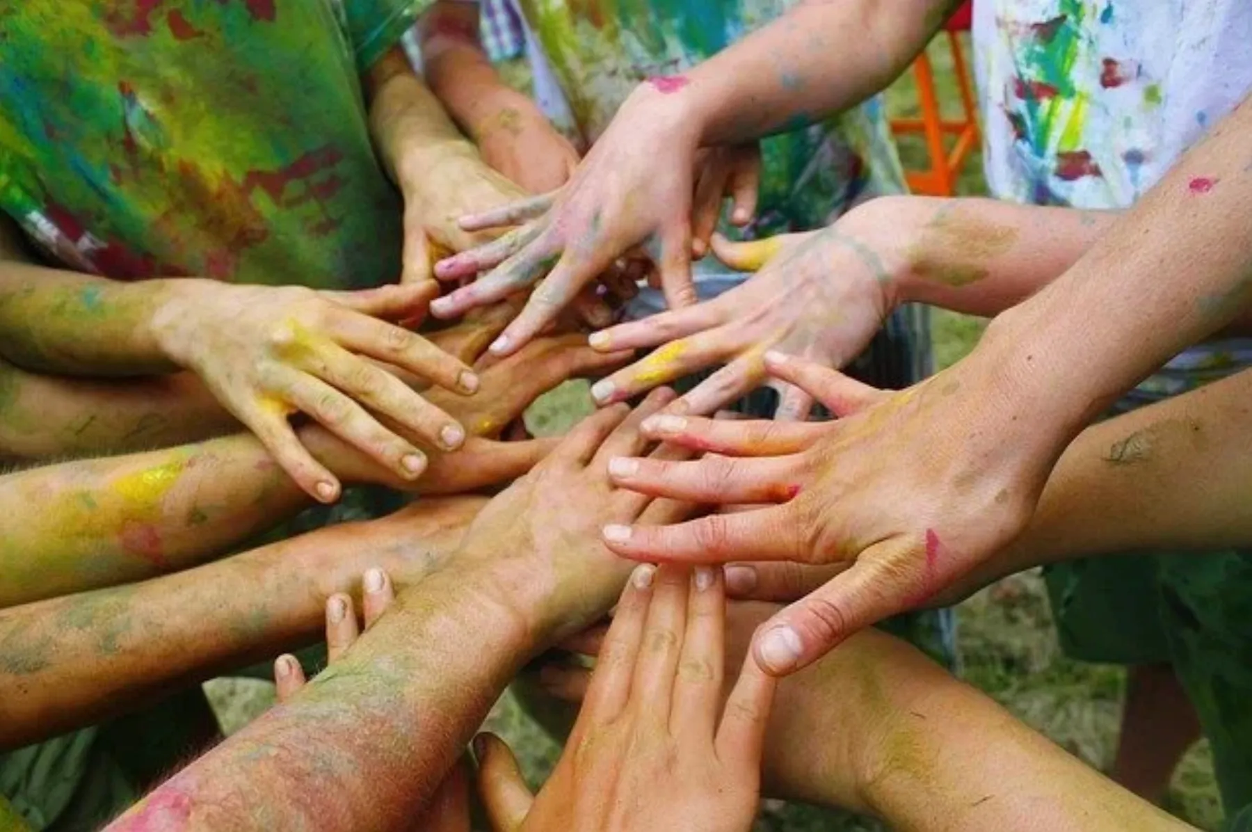 Students bringing their hands together as a team